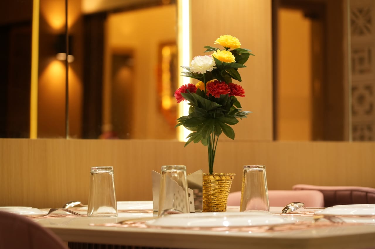 Elegant dining table setup at Hotel The Grand Om Krishna restaurant